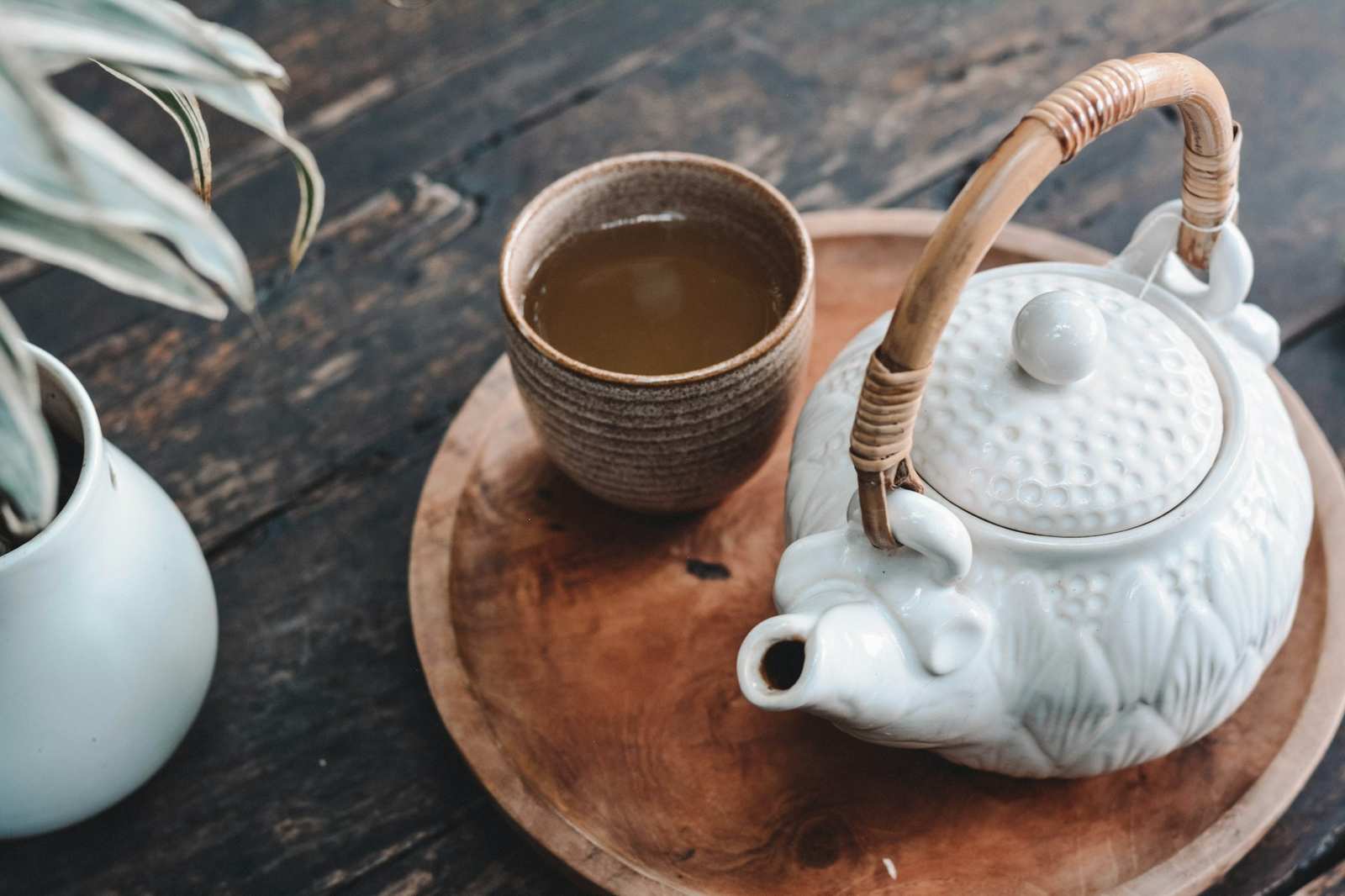 Ấm trà bốc khói trên bàn gỗ mộc (ảnh mẫu)